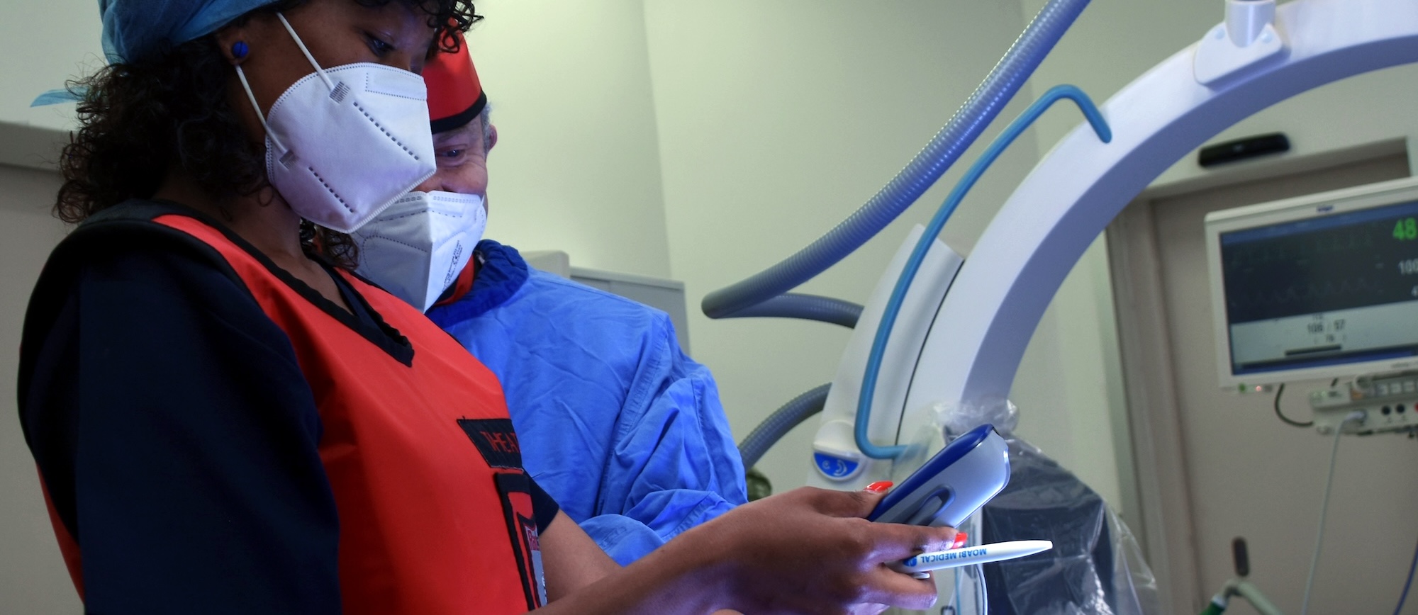 JAUC Surgeon and Medtronic device expert testing a patient's newly implanted neurostimulator